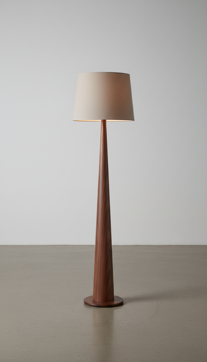 A walnut wood floor lamp standing centered in a minimalist studio setting. Captured at a 3/4 angle, the image emphasizes...
